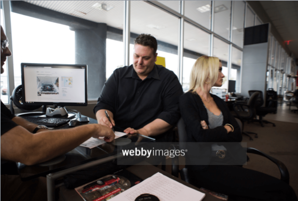 Man and Woman Buy Car Stock Photo